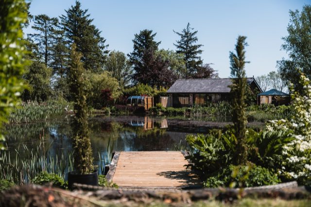Luxury Lakeview Retreat: The lodge across the lake, seen from the wooden jetty