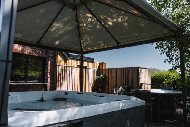 Luxury Lakeview Retreat: Hot tub under its canopy on the deck