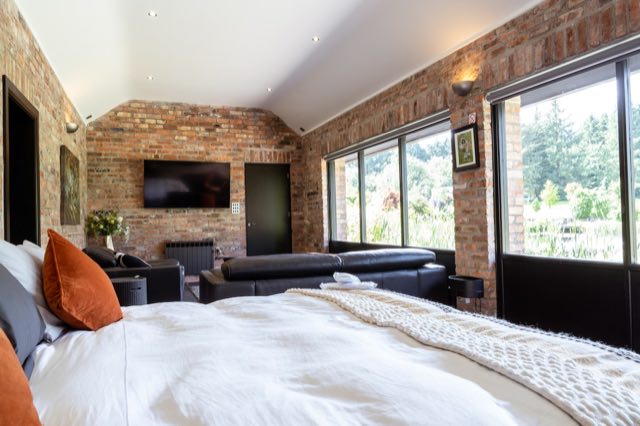 Luxury Lakeview Retreat: View from the bed towards the TV and garden windows