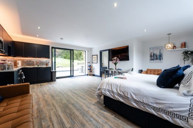 Luxury Studio: Open-plan studio with the super king bed, kitchen and sliding doors to the patio
